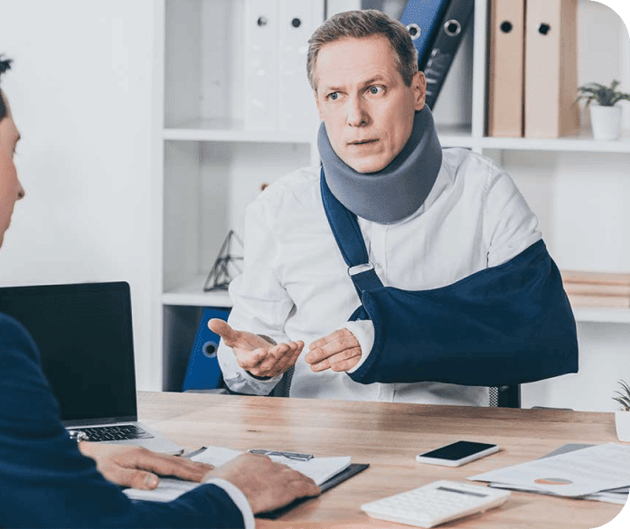 Man with his arm in sling talking to his attorney